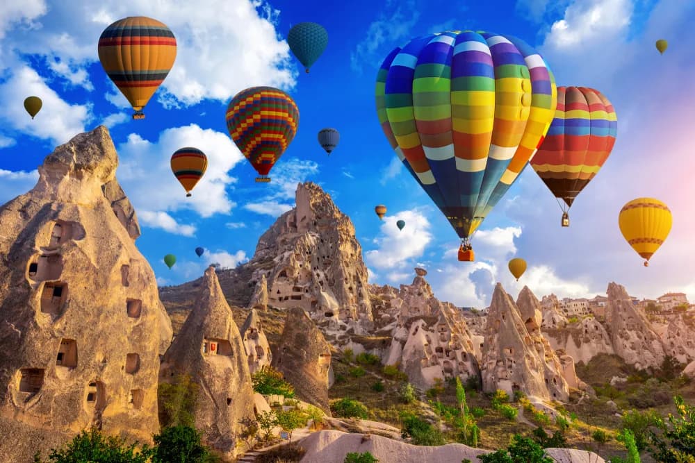 Hot air balloons over the fairy chimneys of Cappadocia at sunrise