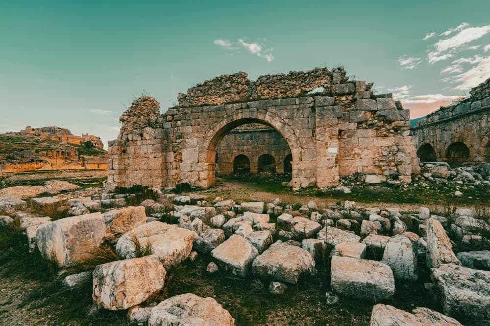 The Roman-era arched gate ruins at the ancient city of Perge, near Antalya