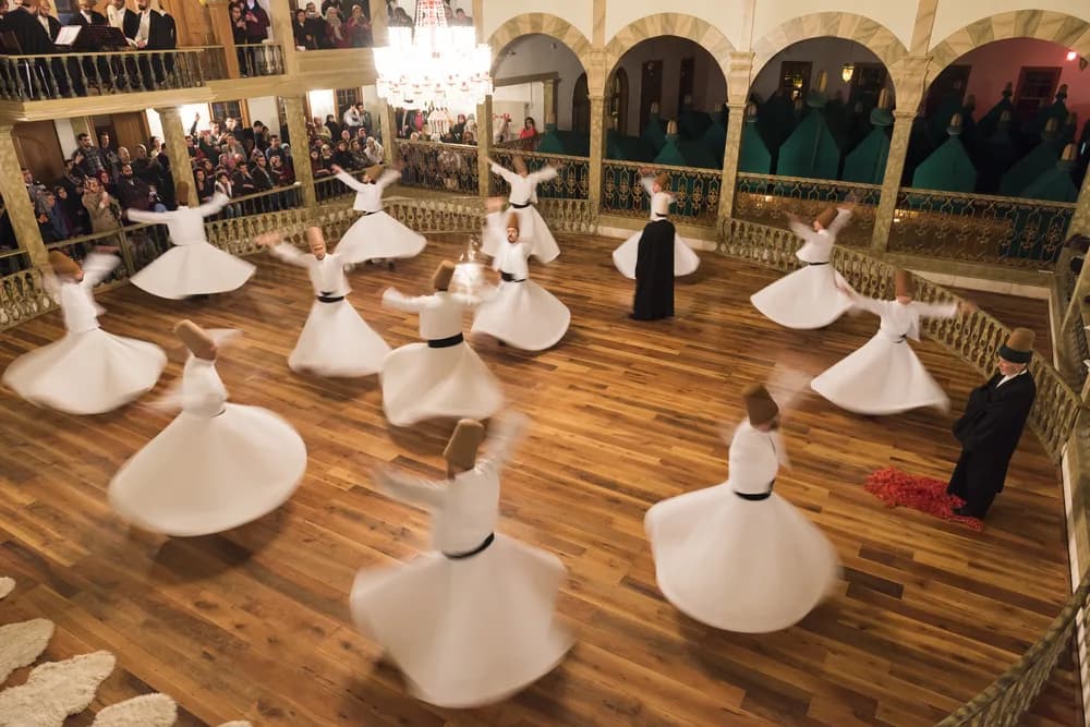 Whirling dervishes performing the Sema ceremony in traditional white robes
