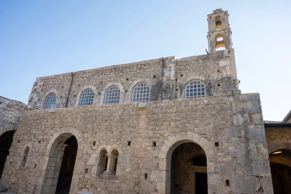 A historic stone church with a bell tower