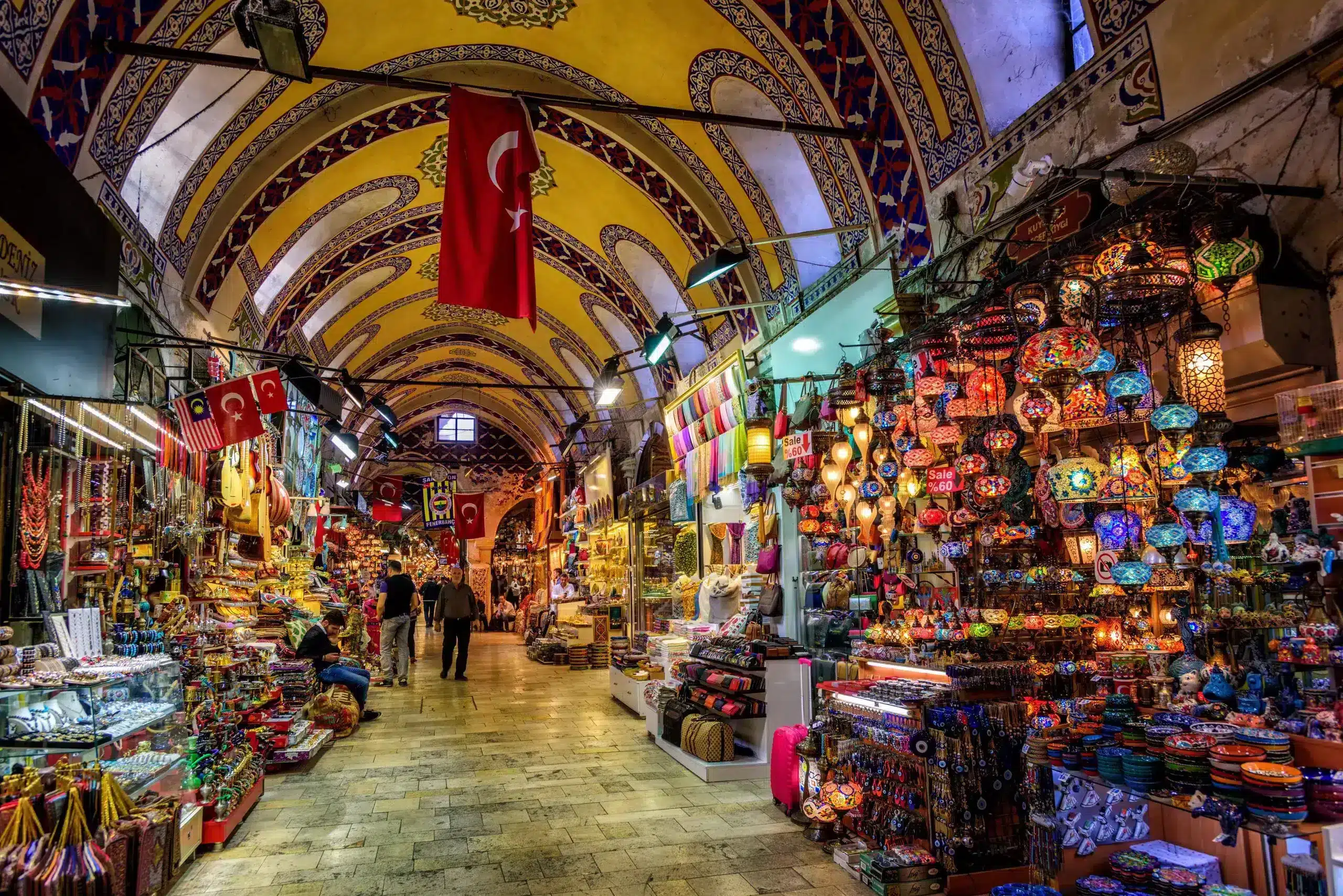 a large market with many colorful objects with Grand Bazaar, Istanbul in the background