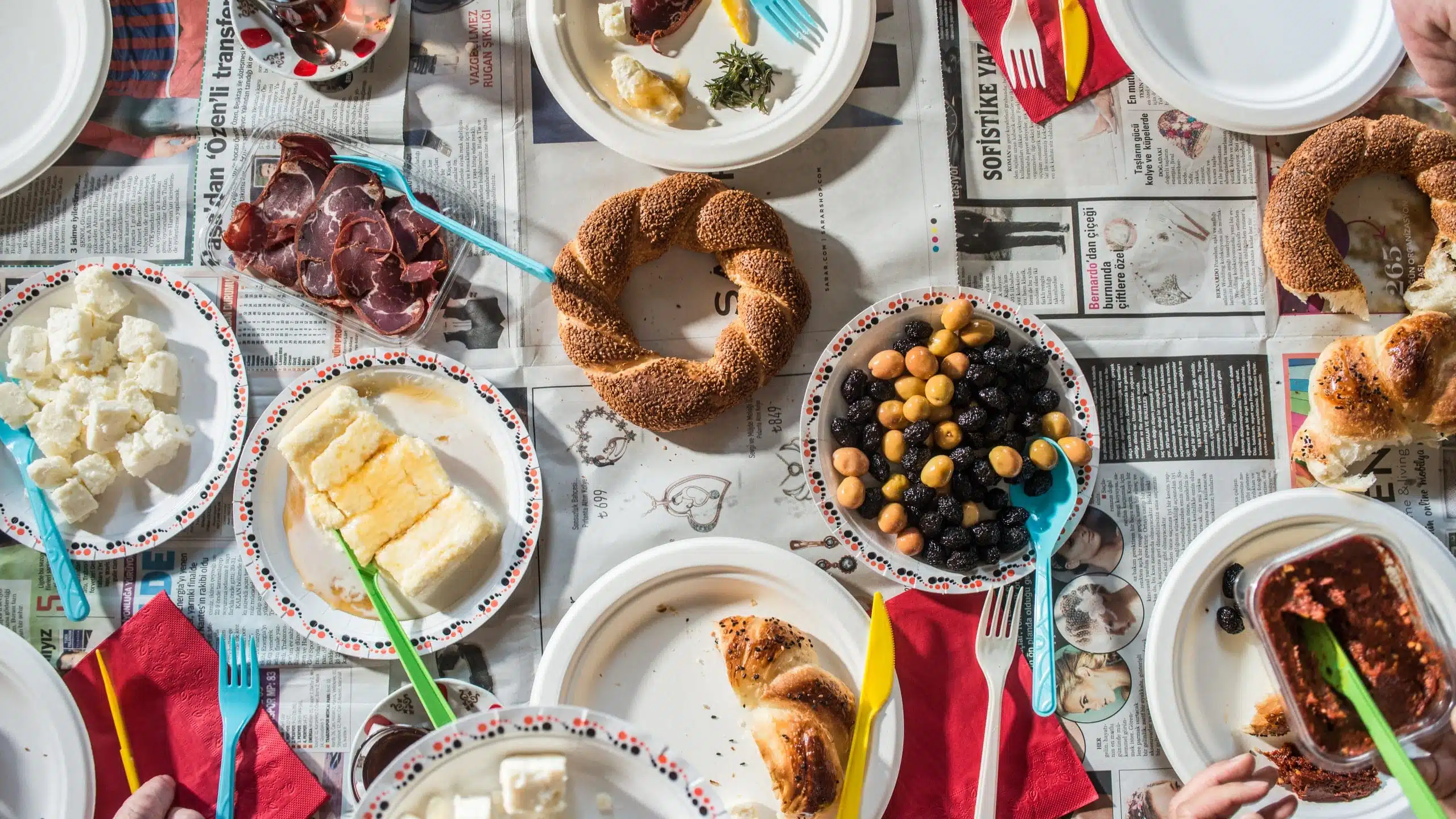 a table with plates of food and forks