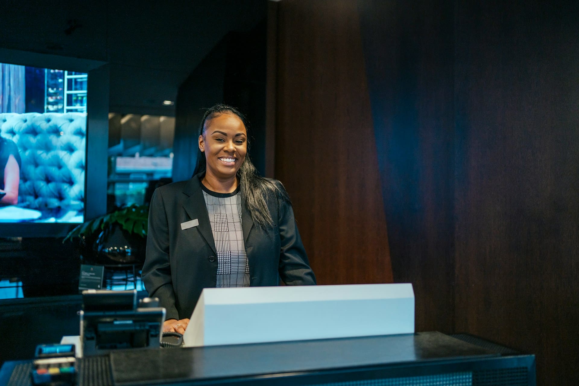 a woman standing behind a desk